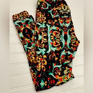 Worn Once TC LuLaRoe Leggings Fits 12-20. Brown Background With Scroll Print